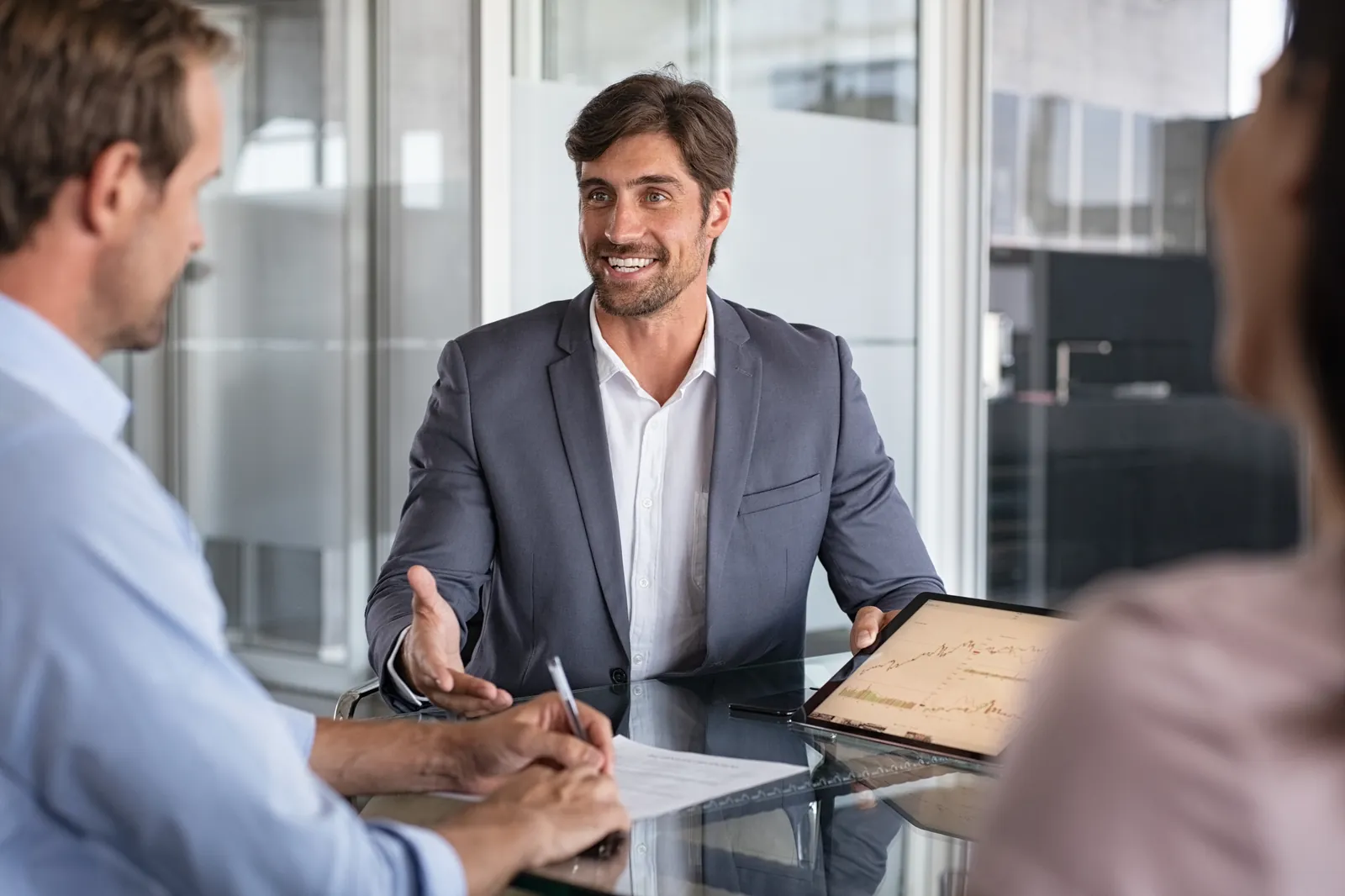 Financial adviser discusses documents with clients